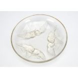 A Rene Lalique opalescent glass footed dish Nonnettes pattern, the circular shallow dish decorated