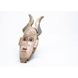 A Senufo painted mask, Ivory Coast, length 40cm