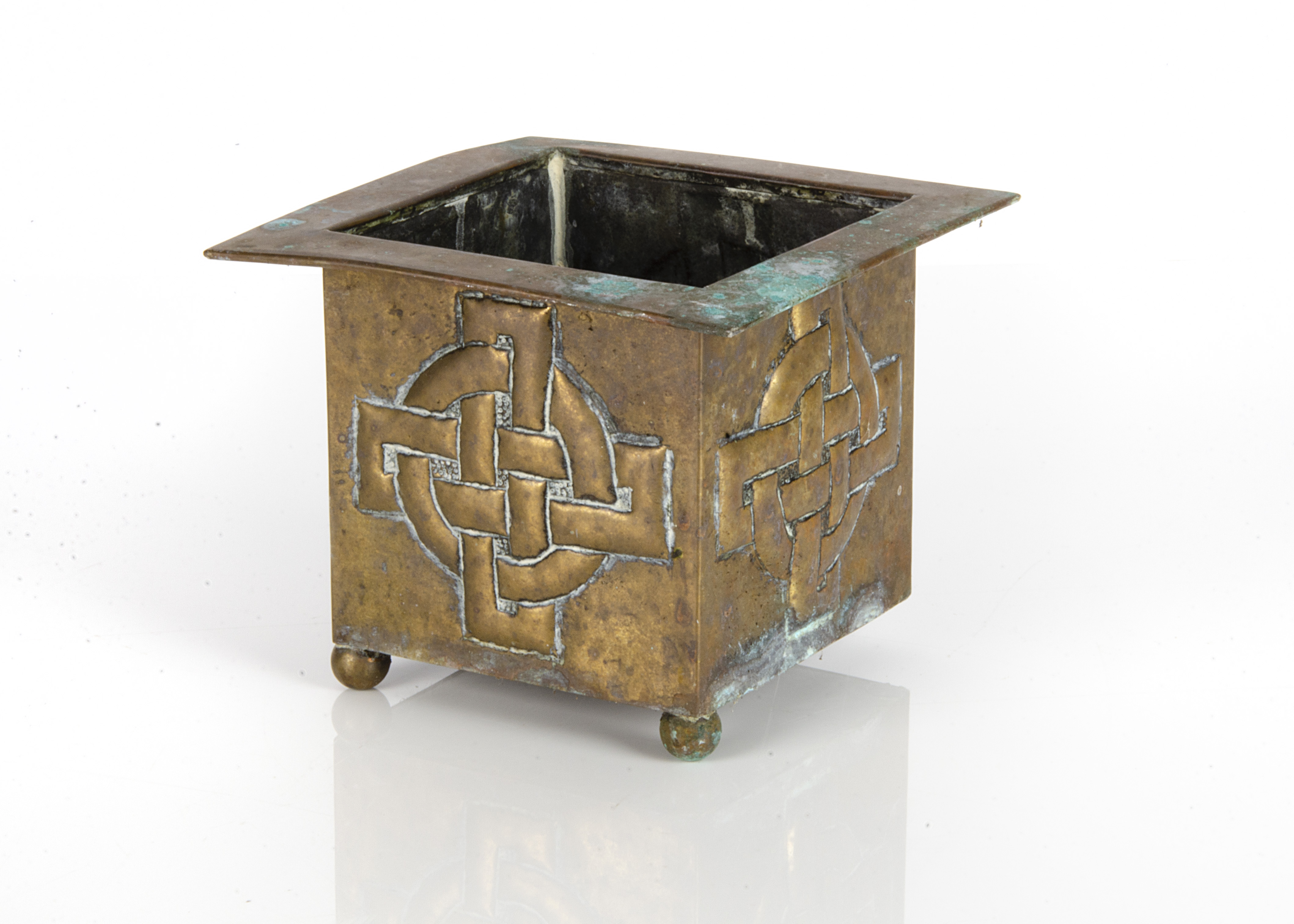 A brass Arts and Crafts Celtic designed jardiniere, of square form with knotted Celtic cross