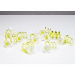 A collection of ten hand blown table ornaments, possibly napkin holders, all of floral design with