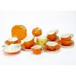 A Crown Devon orange moulded and pattern part tea set, comprising six cups, six saucers, one side