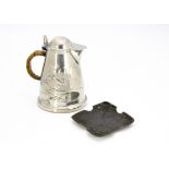A Tudric pewter hot water jug, designed by Archibald Knox, the tapered body with flower heads and