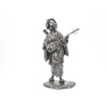 A Japanese Meiji period bronze figure, modelled as a female musician standing, singing with Japanese