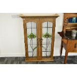 A contemporary oak and glazed panelled display cabinet, the glazed Art Nouveau lead lined panels