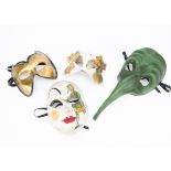 A contemporary plague mask, the papier mache plague mask in green with elongated nose, together with