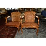 A pair of 19th Century continental walnut framed carved bergère armchairs, the single carved seat
