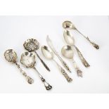 A collection of continental white metal Art Nouveau caddy spoons, butter knives, preserve spoons,
