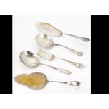 A collection of silver plated and white metal serving implements, including asparagus forks, fish