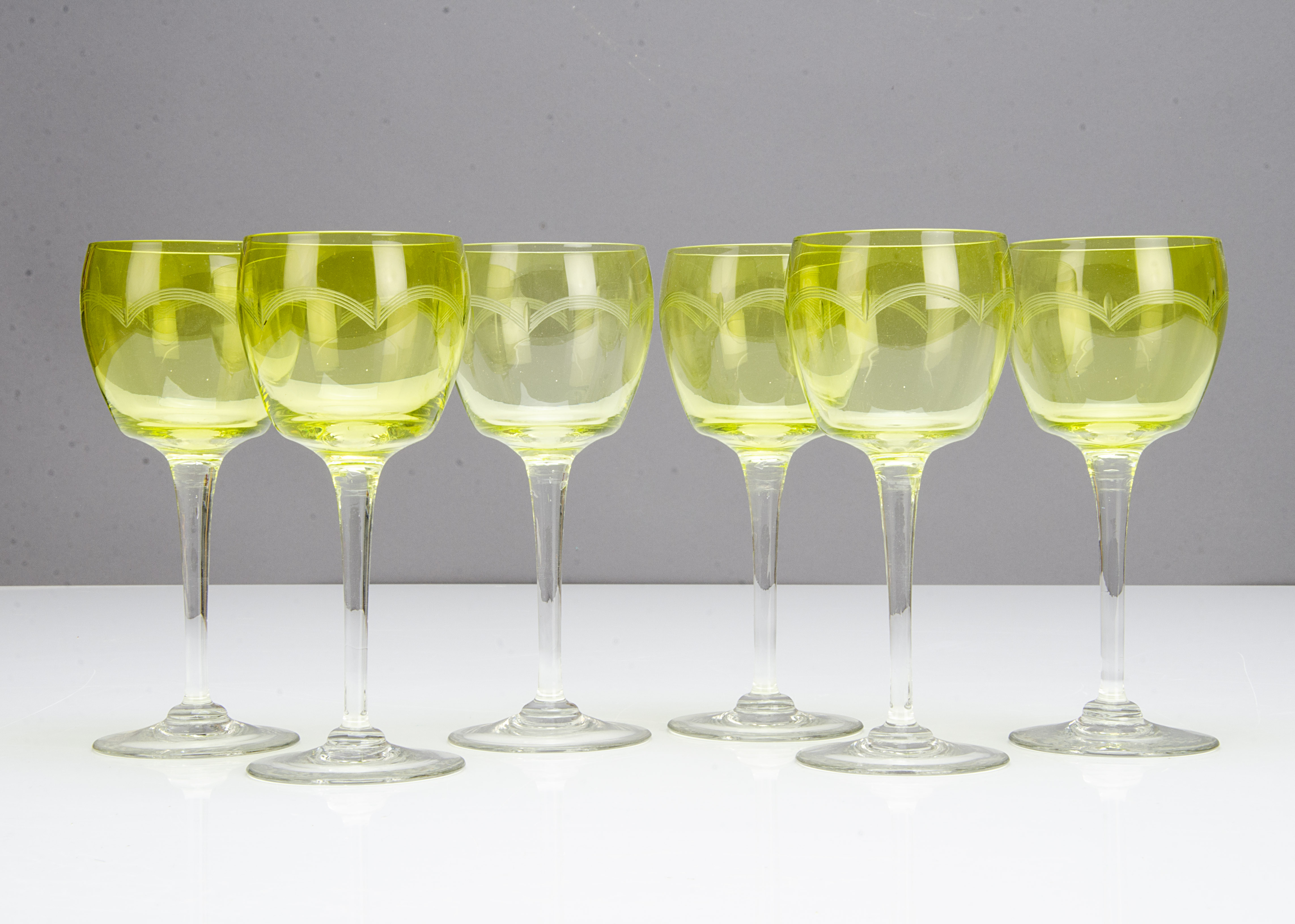 A set of six continental early 20th Century green bowled wine glasses, with wheel engraved arched - Image 2 of 2