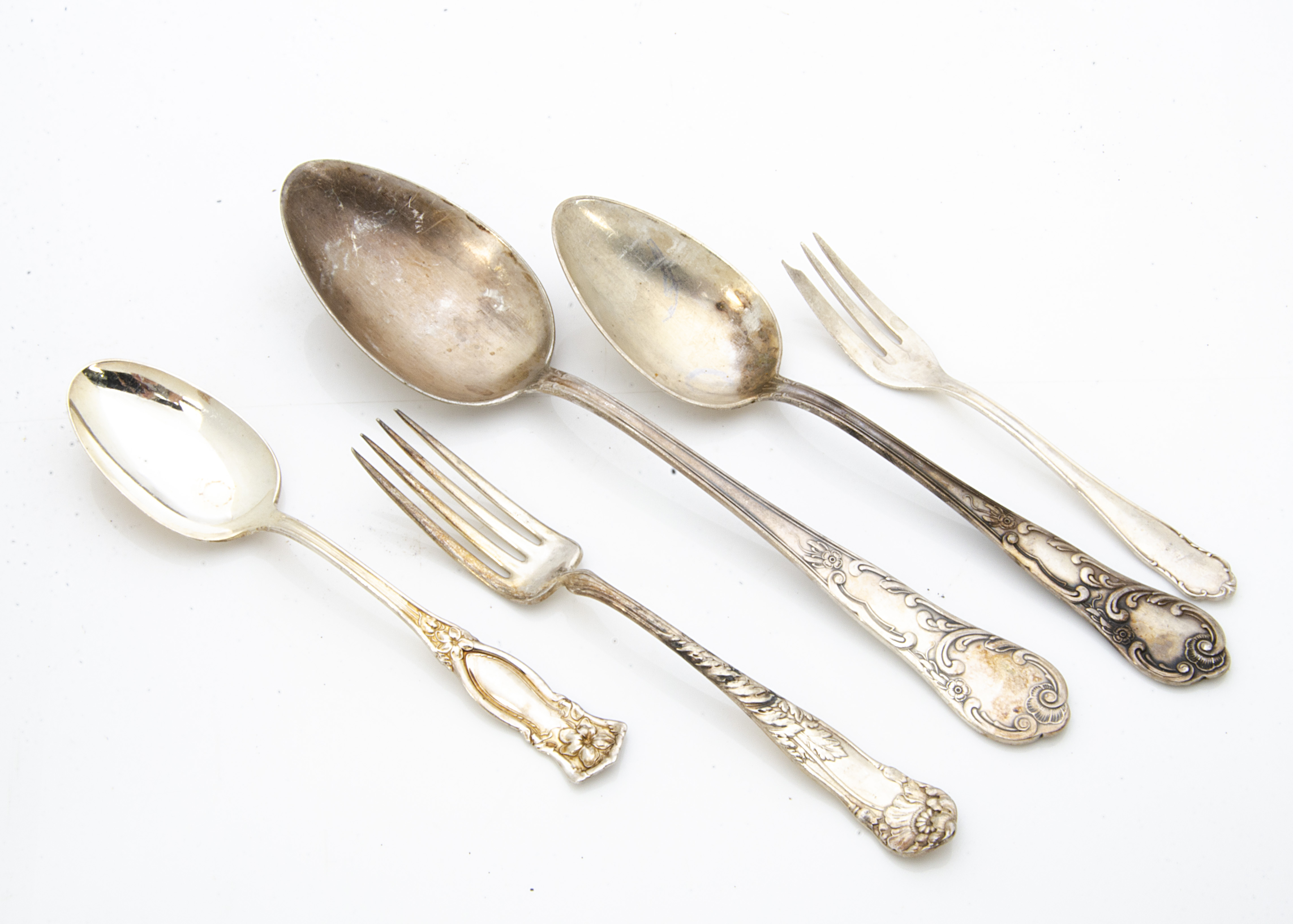 A collection of various continental silver plated Art Nouveau flatware, including spoons, forks,