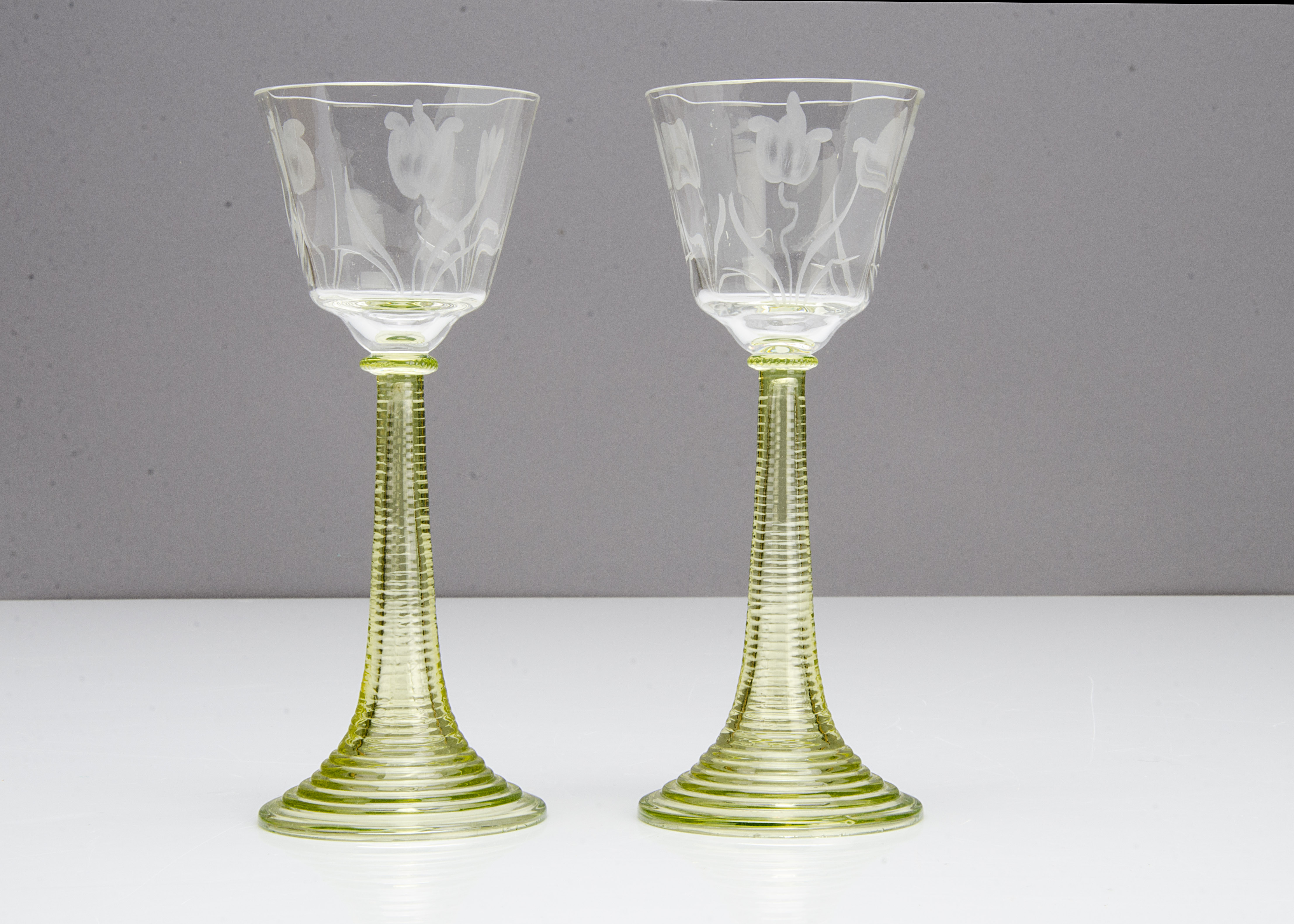 A pair of continental engraved Art Nouveau wine glasses, the tapered bowls with stylised floral - Image 2 of 2