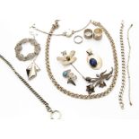 A collection of white metal and silver jewellery, including a Mexican and tiger's eye pin brooch,