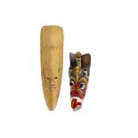 Two Javanese / Balinese masks, one polychrome decorated, length 38cm