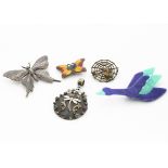 A collection of mixed media insect and animal pendants and brooches, comprising a Lea Stein goose