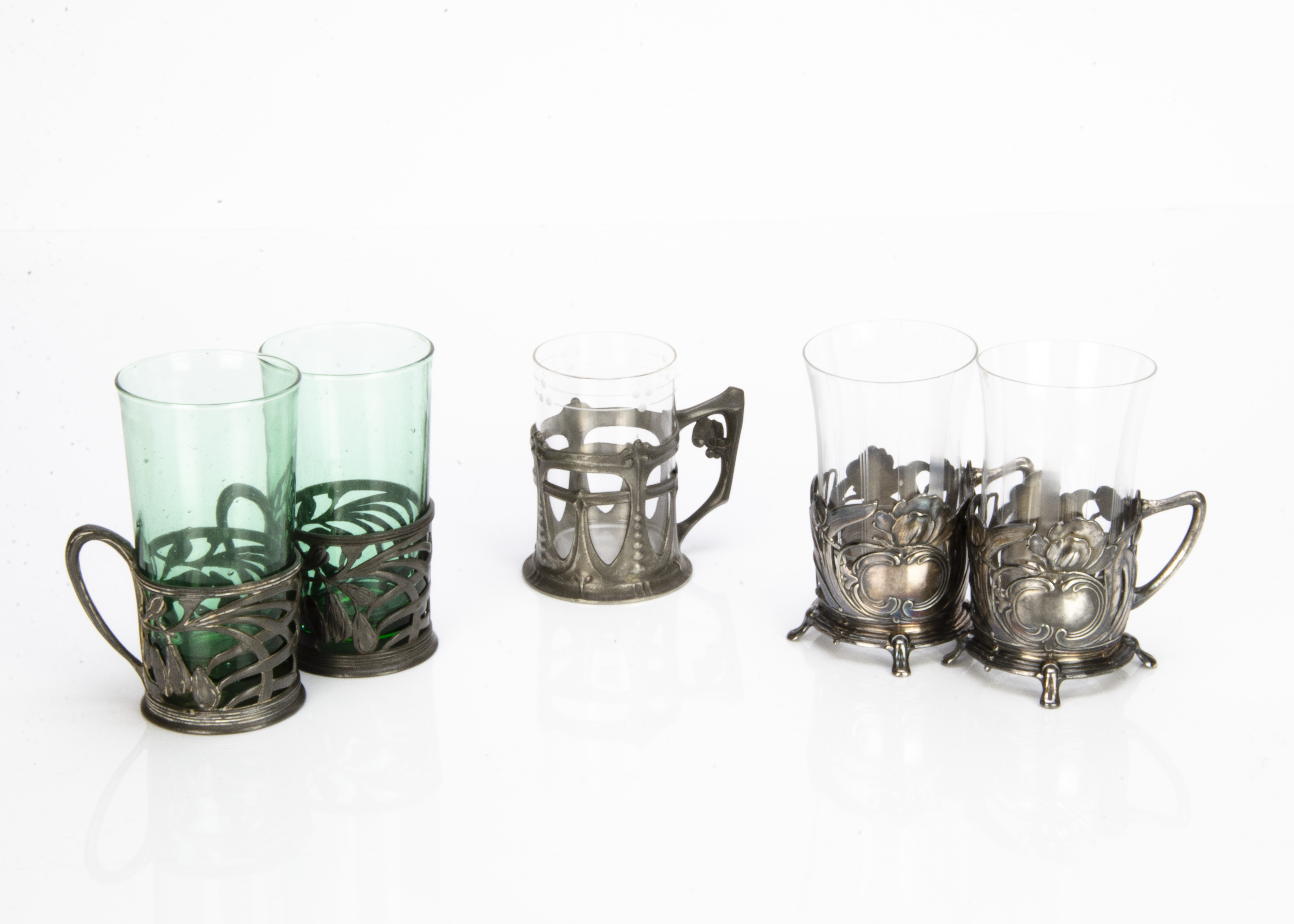 A pair of Orivit pewter Jugendstil glass or cup holders, decorated with pierced design of flower