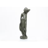 An Art Nouveau plaster figure of a young nude woman awakening, standing with one arm raised