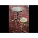 A 19th Century mahogany tilt top table, the turned pedestal on cabriole tripod supports, circular