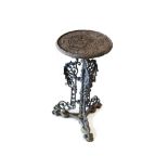 A cast iron garden table, the small circular top with moulded design on single pedestal with three