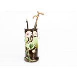 A large continental Art Nouveau majolica stick stand, of cylindrical form decorated with pink