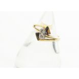 A 14ct gold diamond set crossover dress ring, the brilliant cuts in four claw setting on yellow gold