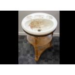 An Edwardian wash basin, the pottery circular top in an Aesthetic design decorated with birds within