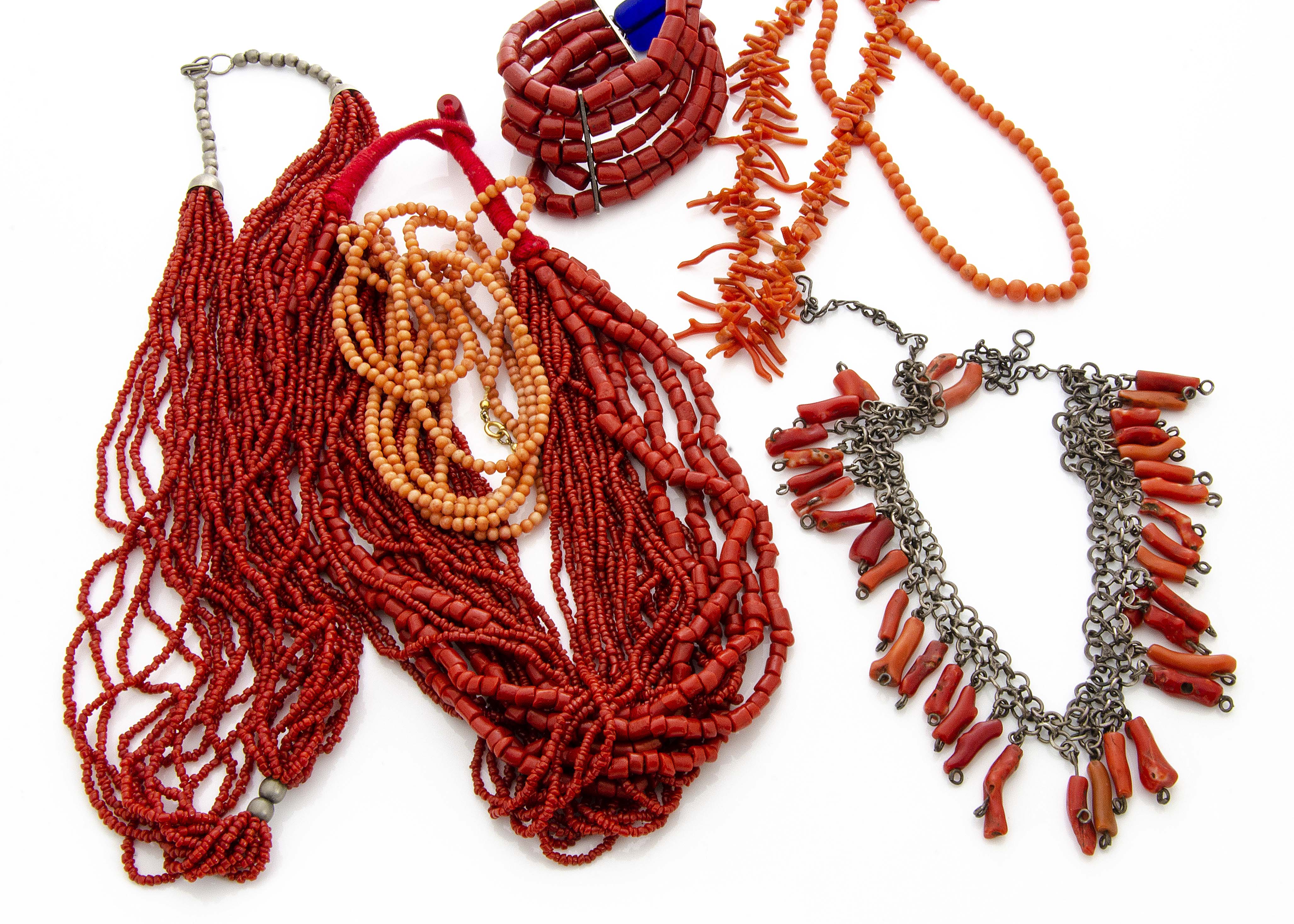 A collection of coral jewellery, including a Middle Eastern white metal and coral fringe necklace, a