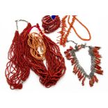 A collection of coral jewellery, including a Middle Eastern white metal and coral fringe necklace, a