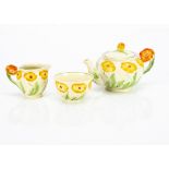 A Grindley Pottery Art Deco three piece teaset, the bachelor tea set with moulded yellow flower