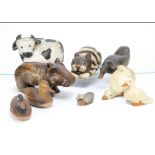 A collection of wooden carved animals, including a black and white striped pussycat with green