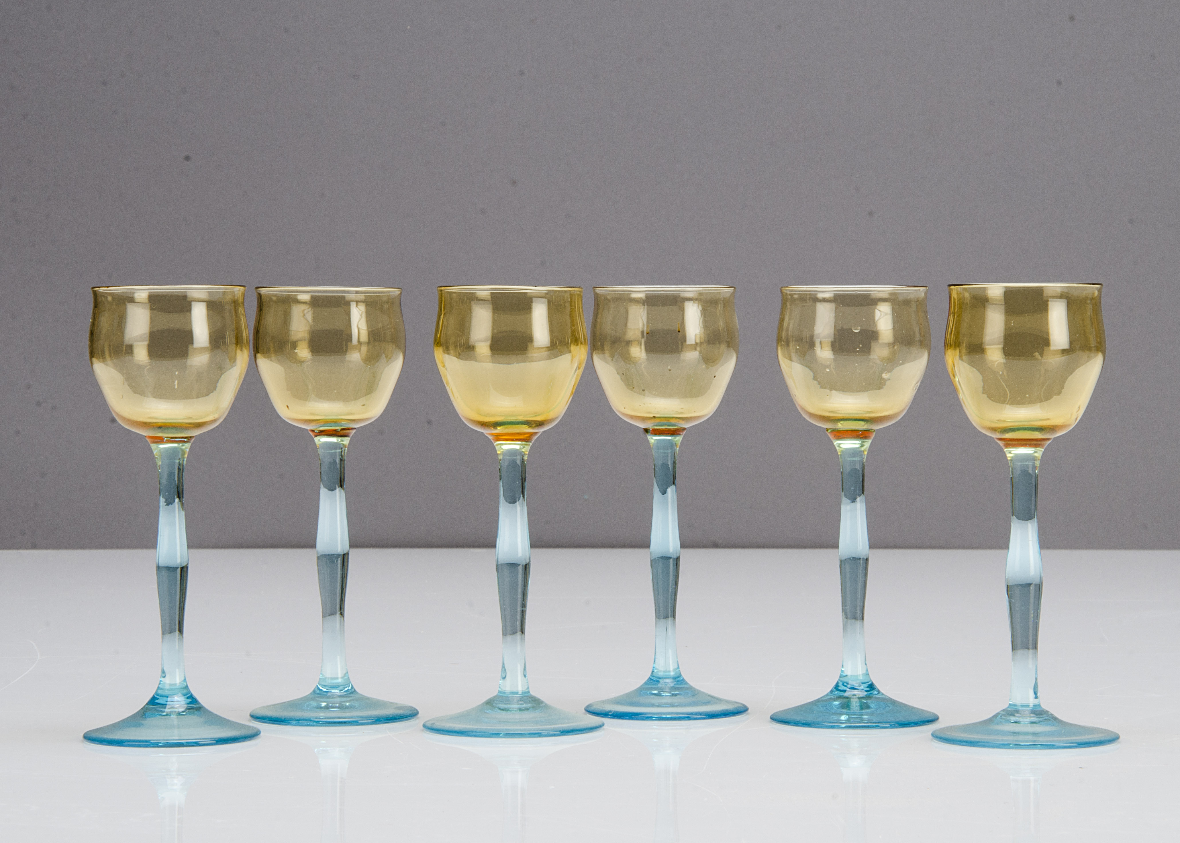 Six German Art Nouveau liquor glasses, the tulip shaped amber bowls supported on shaped blue stems - Image 2 of 2