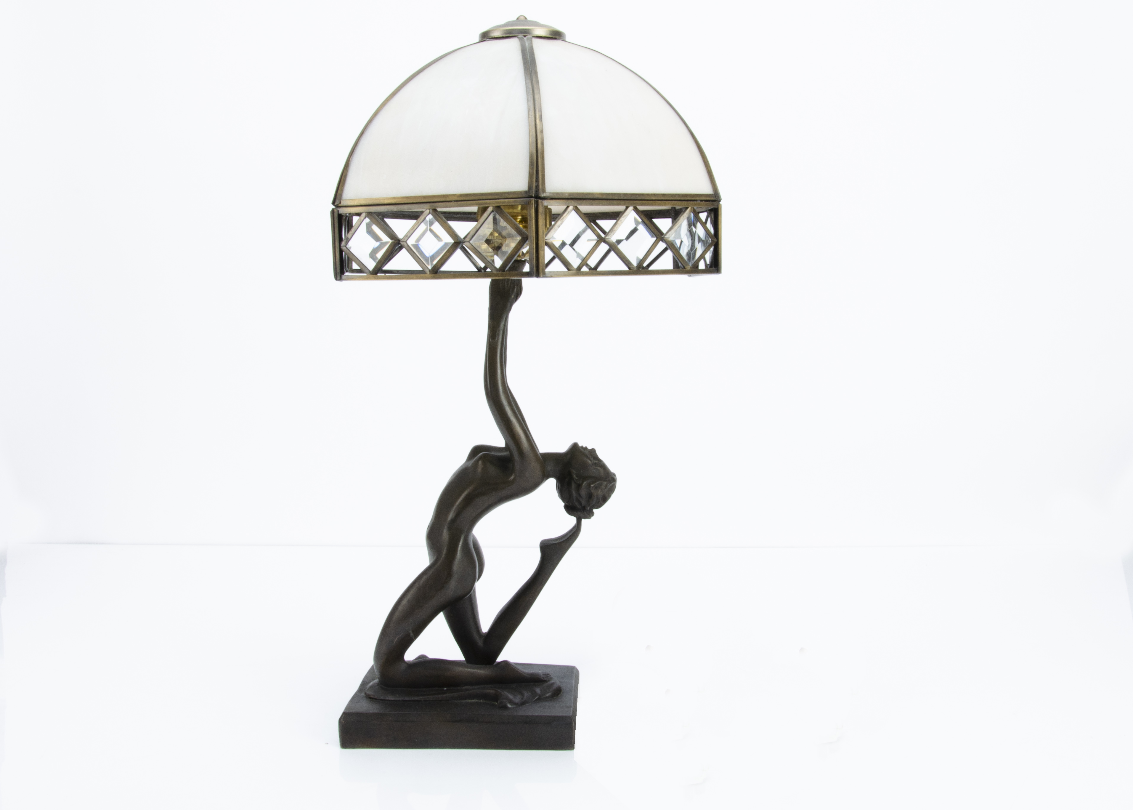 An Art Deco style resin figural lamp base, modelled as a nude female in a kneeling pose with arms