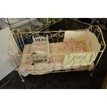 An iron painted child's cot, circa 1900, 61cm wide x 130cm x 89cm high, with contemporary Winnie the