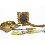 A collection of pressed brass Art Nouveau ware, including a crumb tray and brush, pressed photograph