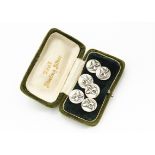 A set of six continental Art Nouveau white metal circular buttons, with stylised irises in relief