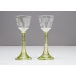 A pair of continental engraved Art Nouveau wine glasses, the tapered bowls with stylised floral