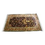 A Middle Eastern silk prayer rug, the all over floral decoration with a large urn of multiple