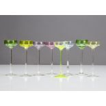 A set of eight shallow bowled Art Nouveau liquor glasses, each bowl in varying colours of green,