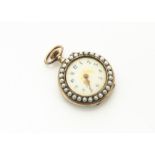 An early 20th Century silver gilt and enamel seed pearl open faced lady's fob watch, the cream