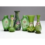 Six Art Nouveau green glass vases, all with painted decoration including a pair of ovoid vases