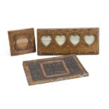 An Art Nouveau leatherette four division heart shape photograph frame, with tooled decoration of