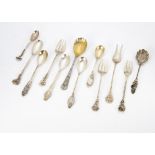 A collection of white metal, silver and silver plated spoons, all with floral terminals, some set