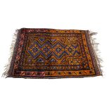 A Middle Eastern woollen beloush style rug, with central orange and blue pattern surrounded by a