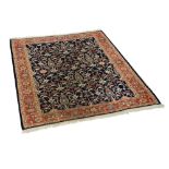 A flat woven woollen carpet, with an all over floral central panel against a blue ground with