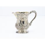 A Victorian white metal jug, similar to a Christening tankard with raised designs and gilt interior,
