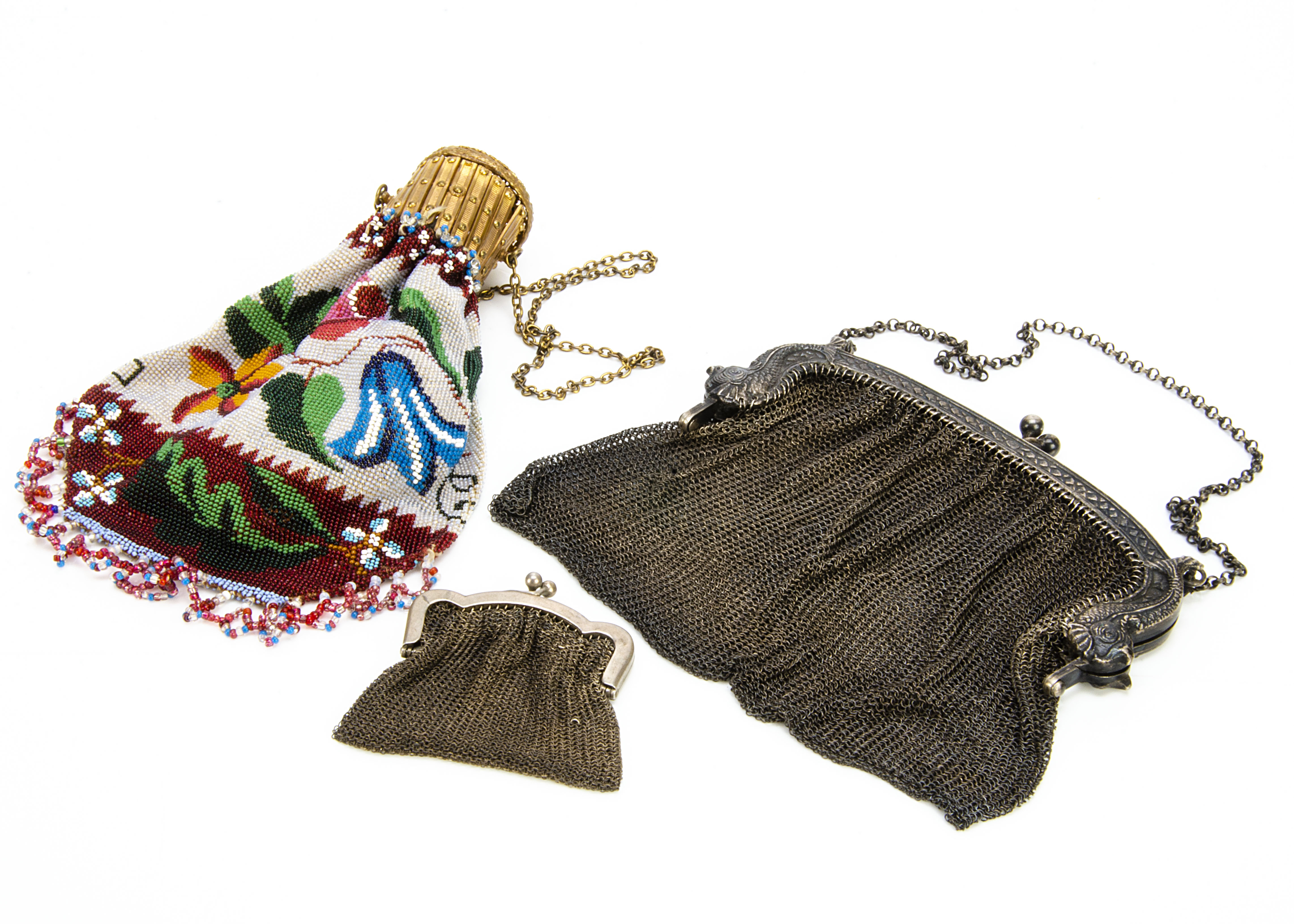 Three late 19th Century purses, one silver with mythical fish and bearing marks, possibly French,