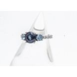 A synthetic colour change alexandrite, topaz and diamond American dress ring, the central mauve claw