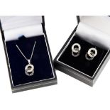 A diamond suite of jewels, including a pendant and pair of earrings, of double loop design, set with