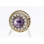 A continental amethyst and seed pearl yellow metal dress ring, the circular cabochon amethyst