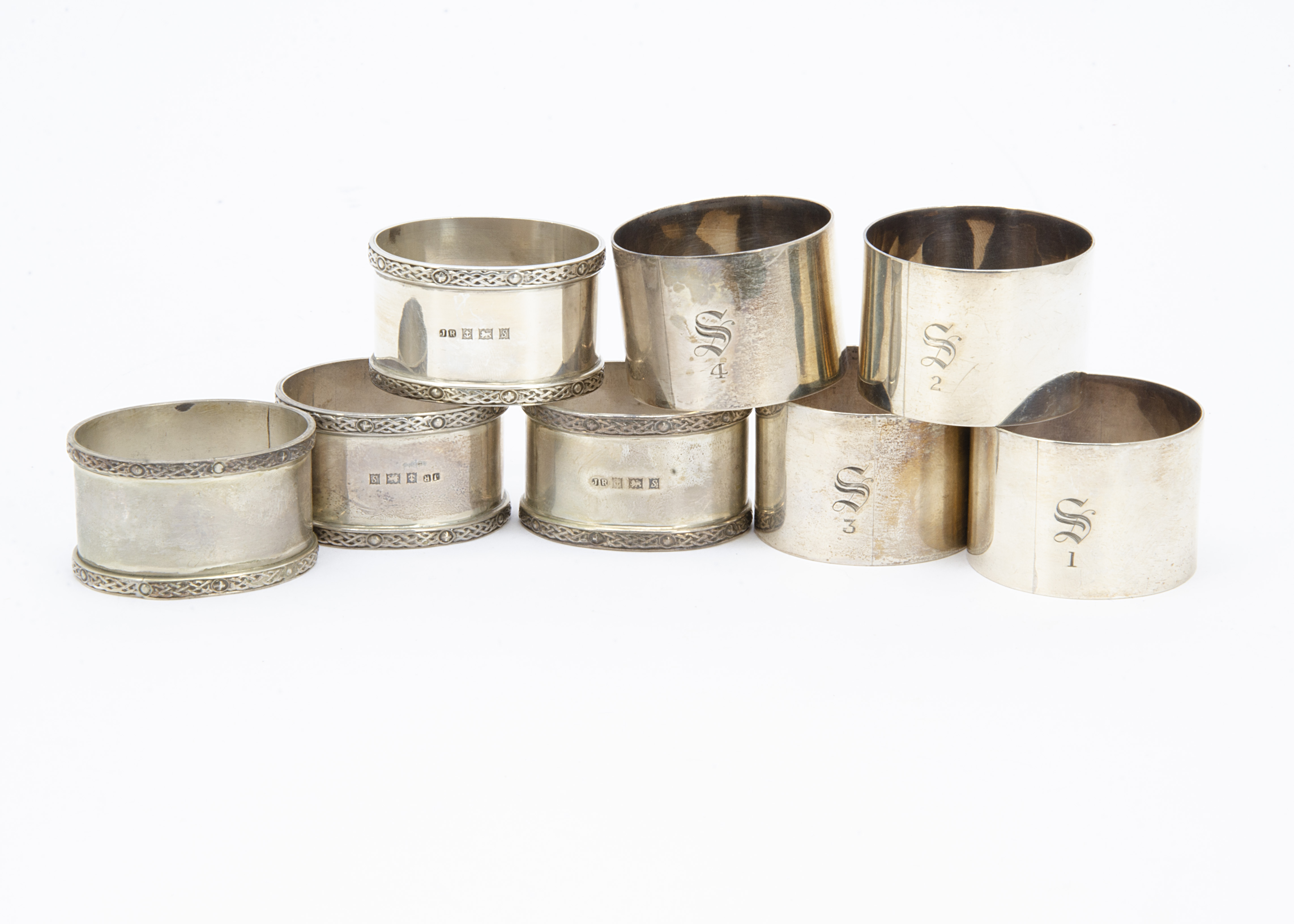 A set of four 1960s silver oval napkin rings from JR, together with a set of four silver napkin