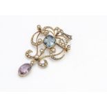 A 15ct gold tourmaline and seed pearl Art Nouveau pendant or brooch, the cushion cut blue tourmaline